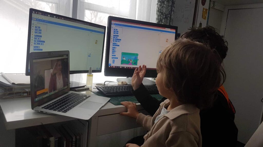 2 learners sitting in front of double monitors