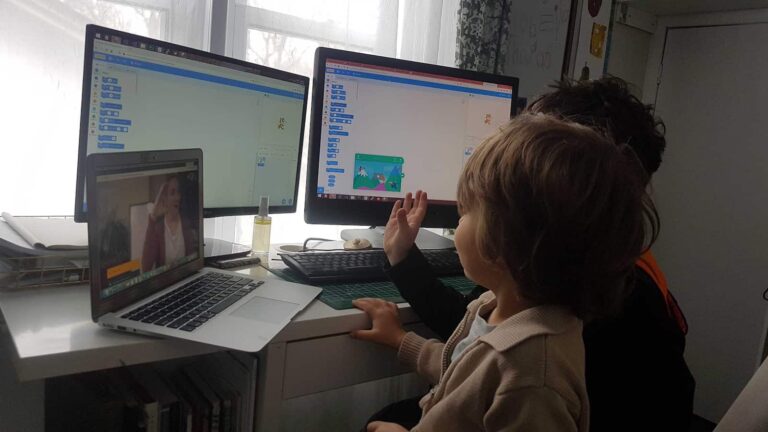 2 learners sitting in front of double monitors
