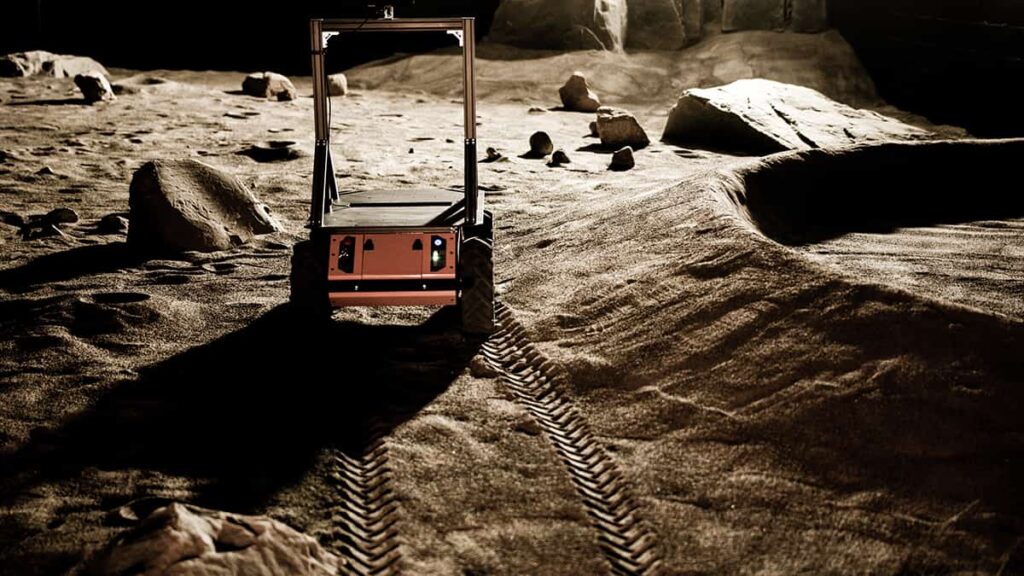 rs-issue5-mission-control-rover-1 with a rocky background|Students learning how to operate a rover on Mars during a production demonstration from a MCSS-Pinnguaq collaboration|Students learning how to operate a rover on Mars during a production demonstration from a MCSS-Pinnguaq collaboration|Students learning how to operate a rover on Mars during a production demonstration from a MCSS-Pinnguaq collaboration|The Mission Control Space Services Rover in motion on Mars