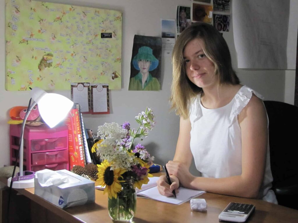 A portrait of Sophie working at a desk.