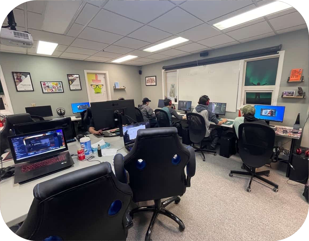 ms-cambridge-bay-makerspace-rectangle An inside look of the Cambridge Bay Makerspace. You can see students working on computers, and many seats with computers sat in front of them.